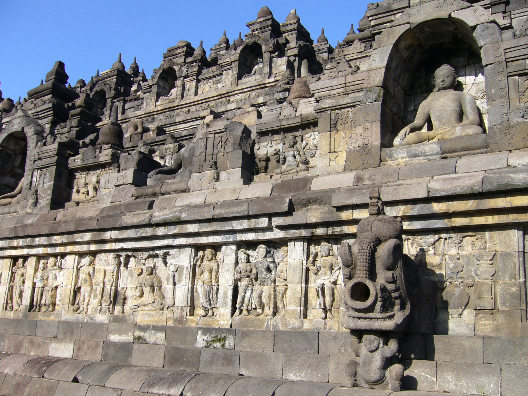 Detailed view of a seated Buddha statue at Borobudur