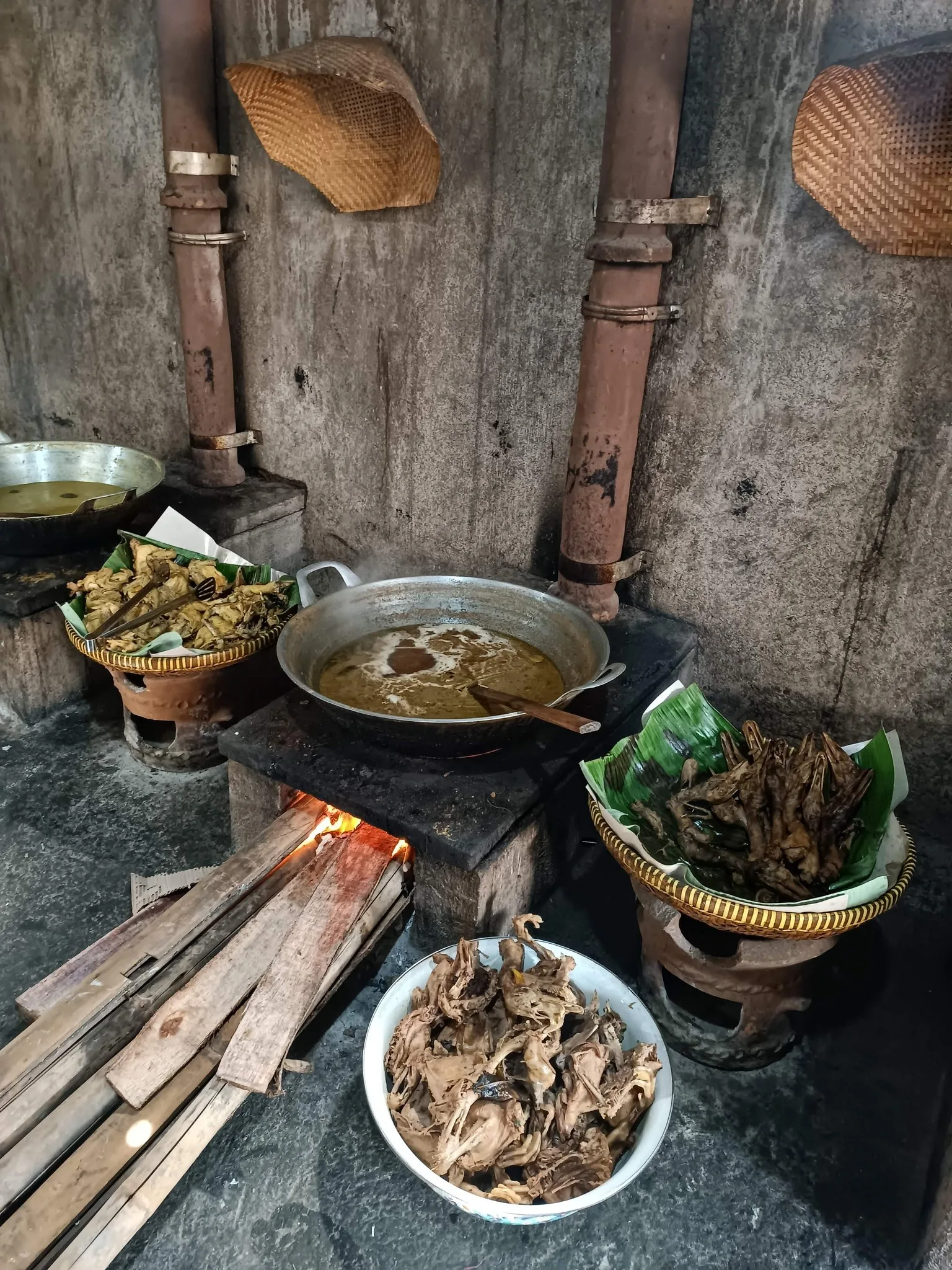 A large cauldron over a wood fire in a Magelang kitchen