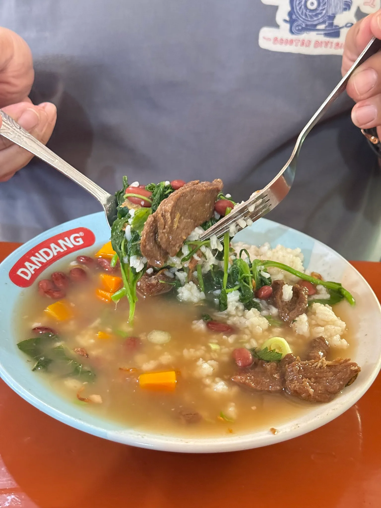 A spoon and fork lifting beef and vegetables from Sop Senerek