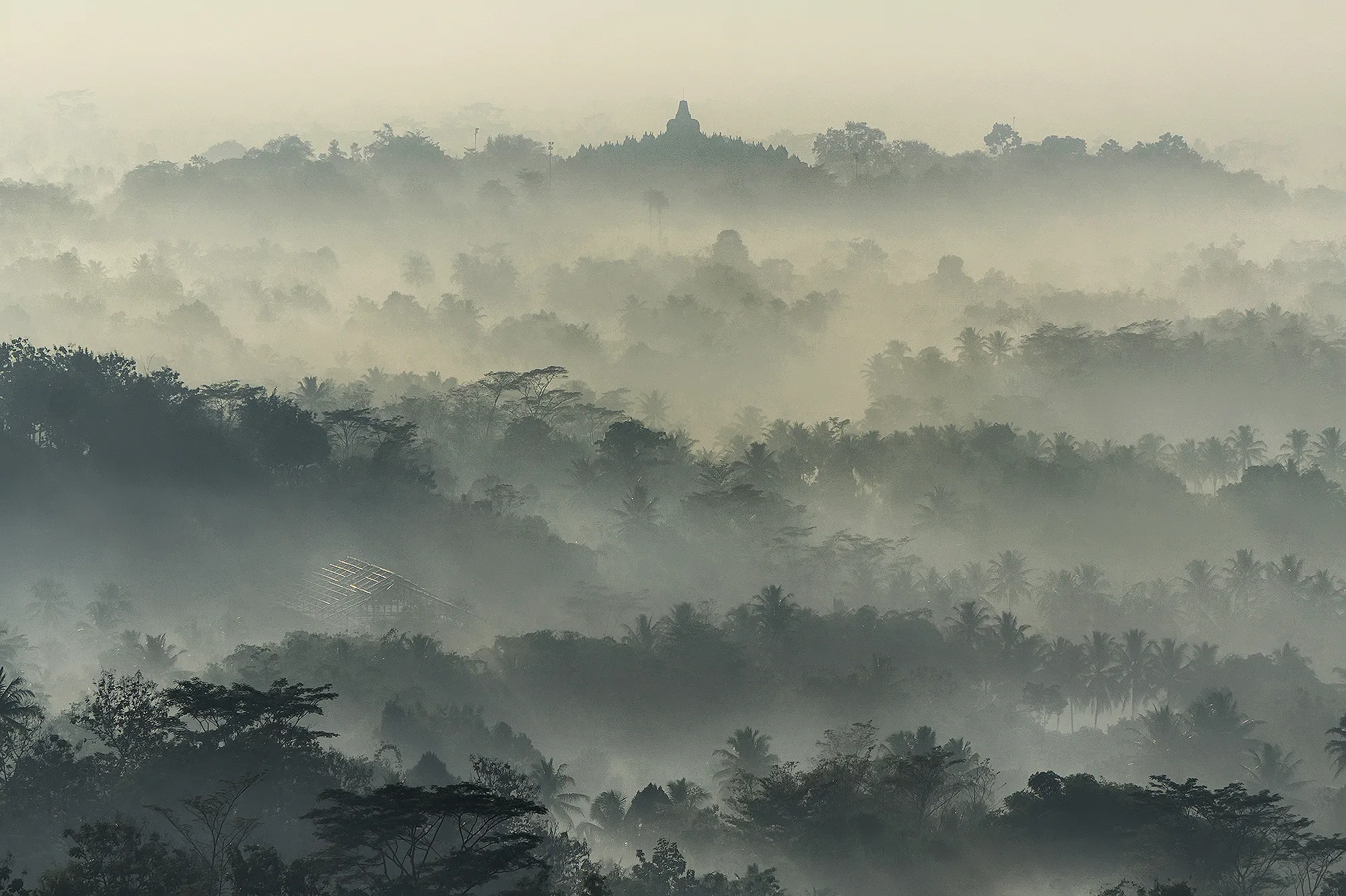 Borobudur Temple silhouette in morning haze seen from Punthuk Setumbu